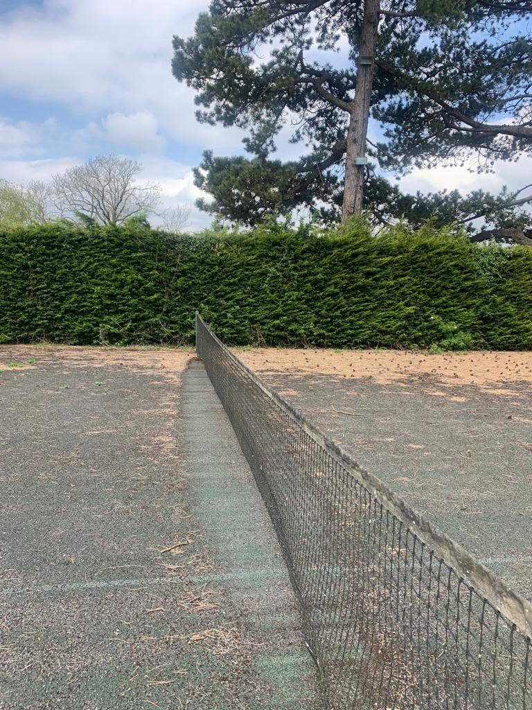 This is a photo of a tennis court in Wiltshire that is in need of refurbishment