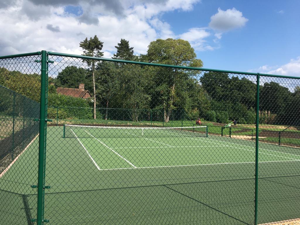 This is a photo of a new tennis court fence installed in Wiltshire, All works carried out by Tennis Court Construction Wiltshire