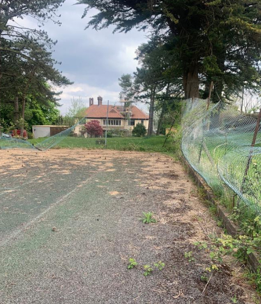 This is a photo of a tennis court in Wiltshire that is in need of refurbishment